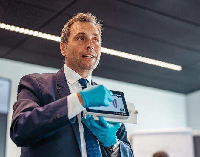 man-in-gloves-holding-tablet-square